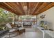 Screened lanai offers comfortable seating and view of the tropical backyard at 1830 Santa Barbara Dr, Dunedin, FL 34698