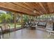 Relaxing screened lanai with wood ceilings and a comfortable seating area at 1830 Santa Barbara Dr, Dunedin, FL 34698