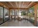 Spacious screened lanai with wood ceiling and outdoor furniture at 1830 Santa Barbara Dr, Dunedin, FL 34698