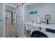 Charming laundry room offers utility sink, storage, and modern washer/dryer at 1830 Santa Barbara Dr, Dunedin, FL 34698