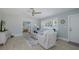 Inviting living room featuring a coastal design, ceiling fan, and lots of natural light at 1830 Santa Barbara Dr, Dunedin, FL 34698