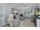 Bright living room features neutral paint, updated floors and a bamboo mirror at 1830 Santa Barbara Dr, Dunedin, FL 34698