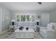 Bright living room with a ceiling fan, sofa, and bright natural light at 1830 Santa Barbara Dr, Dunedin, FL 34698
