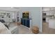 Living room showcases stylish storage, seating and seamless flow to kitchen at 1830 Santa Barbara Dr, Dunedin, FL 34698
