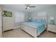 Cozy main bedroom with a ceiling fan, comfortable bed, and lots of natural light at 1830 Santa Barbara Dr, Dunedin, FL 34698