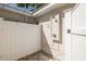 A pristine outdoor shower featuring clean, white paneling with a stone floor at 1830 Santa Barbara Dr, Dunedin, FL 34698