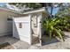 Outdoor shower featuring a white privacy fence and stone landscaping at 1830 Santa Barbara Dr, Dunedin, FL 34698