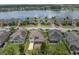 An aerial view of a neighborhood showcasing a lake behind homes, several with solar panels at 19326 Long Lake Ranch Blvd, Lutz, FL 33558