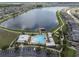 A stunning aerial view showcasing the community pool, lake, and surrounding neighborhood at 19326 Long Lake Ranch Blvd, Lutz, FL 33558