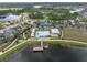 Aerial view of the community featuring a resort-style pool, tennis courts, walking trail, and picturesque lakes at 19326 Long Lake Ranch Blvd, Lutz, FL 33558
