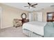 Spacious bedroom with neutral carpet, a ceiling fan, and ample closet space at 19326 Long Lake Ranch Blvd, Lutz, FL 33558