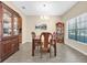 Elegant dining room featuring a classic chandelier, complemented by two wooden china cabinets at 19326 Long Lake Ranch Blvd, Lutz, FL 33558