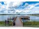 A picturesque view of a community dock and lake, offering residents access to water activities at 19326 Long Lake Ranch Blvd, Lutz, FL 33558