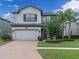 Charming two-story home with a two-car garage, brick paver driveway, and well-manicured landscaping at 19326 Long Lake Ranch Blvd, Lutz, FL 33558