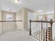 Upstairs hallway featuring neutral carpet, white railings, and natural light at 19326 Long Lake Ranch Blvd, Lutz, FL 33558