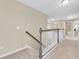 Upstairs hallway featuring neutral carpet and white railings and several rooms leading off at 19326 Long Lake Ranch Blvd, Lutz, FL 33558