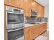 Modern kitchen boasts stainless steel appliances, granite counters, and light wood cabinetry at 19326 Long Lake Ranch Blvd, Lutz, FL 33558