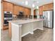 Modern kitchen with stainless appliances, wooden cabinetry, and a large center island at 19326 Long Lake Ranch Blvd, Lutz, FL 33558
