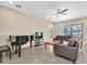 Comfortable living room features a piano, leather sofas, and access to the outdoors at 19326 Long Lake Ranch Blvd, Lutz, FL 33558