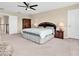 Serene main bedroom featuring a ceiling fan, a walk-in closet, and neutral décor at 19326 Long Lake Ranch Blvd, Lutz, FL 33558