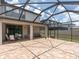 The home has an extended screened patio with tiled flooring, offering ample space for outdoor dining and relaxation at 19326 Long Lake Ranch Blvd, Lutz, FL 33558