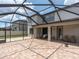 A spacious screened patio, featuring tile flooring, ceiling fan, and an outdoor table with chairs at 19326 Long Lake Ranch Blvd, Lutz, FL 33558