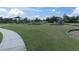Spacious playground with diverse equipment, grassy areas, and a paved walkway for residents at 19326 Long Lake Ranch Blvd, Lutz, FL 33558