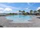 Resort-style community pool with surrounding lounge chairs and lush landscaping, perfect for relaxation at 19326 Long Lake Ranch Blvd, Lutz, FL 33558