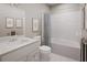 Elegant bathroom with a modern vanity, sleek fixtures, and a shower-tub combination at 20021 Golden Glow Loop, Venice, FL 34292