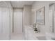 Modern bathroom with double sinks, white cabinetry, and a glass-enclosed shower at 20021 Golden Glow Loop, Venice, FL 34292
