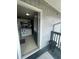 Balcony view into a kitchen, showing outdoor space with rails and building exterior at 203 Pine Violet Ct # 202, Tampa, FL 33612