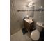 Bathroom featuring a vanity sink, toilet, and a small mirror with white and blue tiles at 203 Pine Violet Ct # 202, Tampa, FL 33612