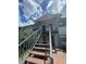 Two story condo building featuring stairs to second floor units and a gray exterior at 203 Pine Violet Ct # 202, Tampa, FL 33612