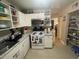 Kitchen featuring appliances and open shelving next to a pantry at 203 Pine Violet Ct # 202, Tampa, FL 33612