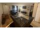 Comfortable living room featuring dark blue sofa, large television, and tiled floor at 203 Pine Violet Ct # 202, Tampa, FL 33612