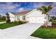 Charming single-story home with a well-manicured lawn and a spacious two-car garage at 272 Voltaire Dr, Spring Hill, FL 34609