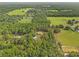 Aerial view of property with surrounding dense trees, farmland, and other homes at 27295 Tarbel Rd, Brooksville, FL 34602