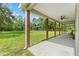 Extended back porch area with view of a large outbuilding in the yard at 27295 Tarbel Rd, Brooksville, FL 34602