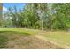 Large backyard with green lawn and a large outbuilding at 27295 Tarbel Rd, Brooksville, FL 34602
