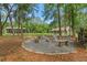 A backyard firepit has seating and a nearby outbuilding and lawn at 27295 Tarbel Rd, Brooksville, FL 34602