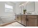 Bright bathroom features a soaking tub, double vanity, and modern fixtures at 27295 Tarbel Rd, Brooksville, FL 34602