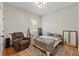Comfortable bedroom with neutral walls, a cozy rug, and large window offering natural light at 27295 Tarbel Rd, Brooksville, FL 34602