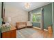 Charming Bedroom features a wooden crib, decorative wall mural, and plenty of natural light at 27295 Tarbel Rd, Brooksville, FL 34602
