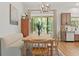Dining area with modern lighting, neutral tones, and a large window, showcasing the natural surroundings at 27295 Tarbel Rd, Brooksville, FL 34602