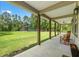 Inviting front porch with rocking chairs and tranquil views of the lawn at 27295 Tarbel Rd, Brooksville, FL 34602