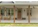 Charming front porch with rocking chairs and a welcoming entrance at 27295 Tarbel Rd, Brooksville, FL 34602