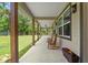 Spacious front porch with rocking chairs and a serene outdoor setting at 27295 Tarbel Rd, Brooksville, FL 34602