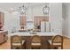 Bright kitchen featuring a center island with seating, stainless steel appliances, and modern pendant lighting at 27295 Tarbel Rd, Brooksville, FL 34602