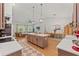 Open-concept kitchen with a large island, modern appliances, and seamless flow to the living and dining areas at 27295 Tarbel Rd, Brooksville, FL 34602