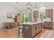 Bright, open kitchen with large island and breakfast bar, flowing into dining area with natural light at 27295 Tarbel Rd, Brooksville, FL 34602